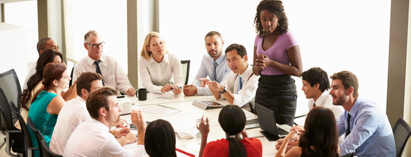 Photo of a team having a discussion in a conference room