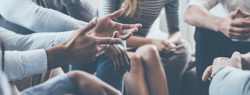 Seek to understand the motivations of your employees. Photo of team focused on one member's outstretched arms