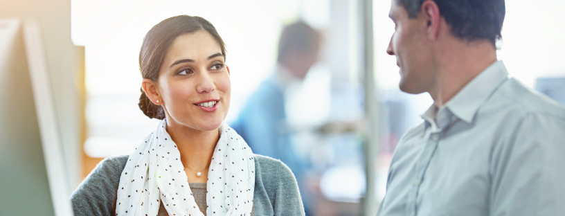 Photo of two co-workers happily collaborating