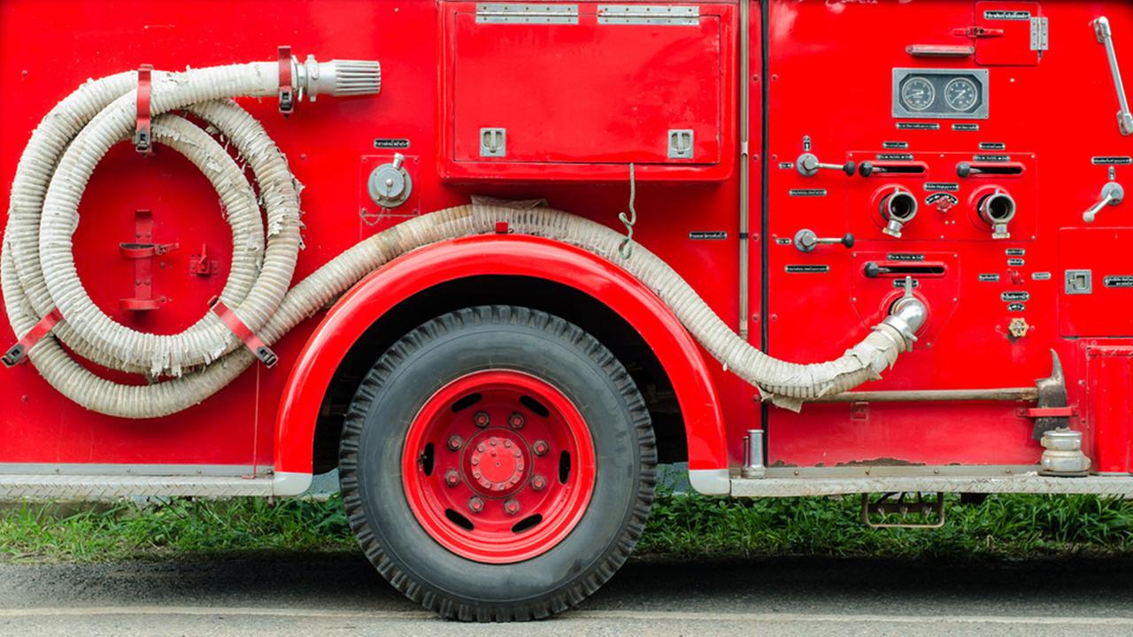 Photo of the side of a red fire truck.