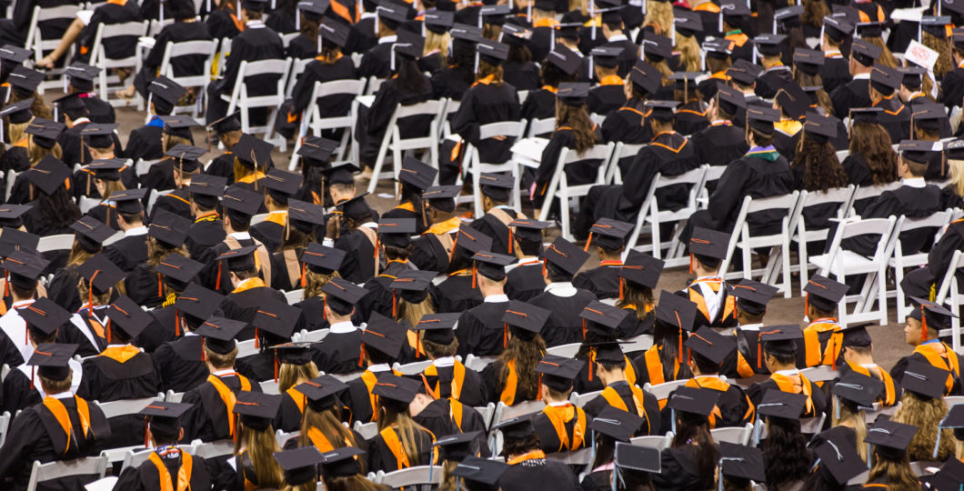 Students who persisted long enough to graduate Photo of college graduates at their ceremony