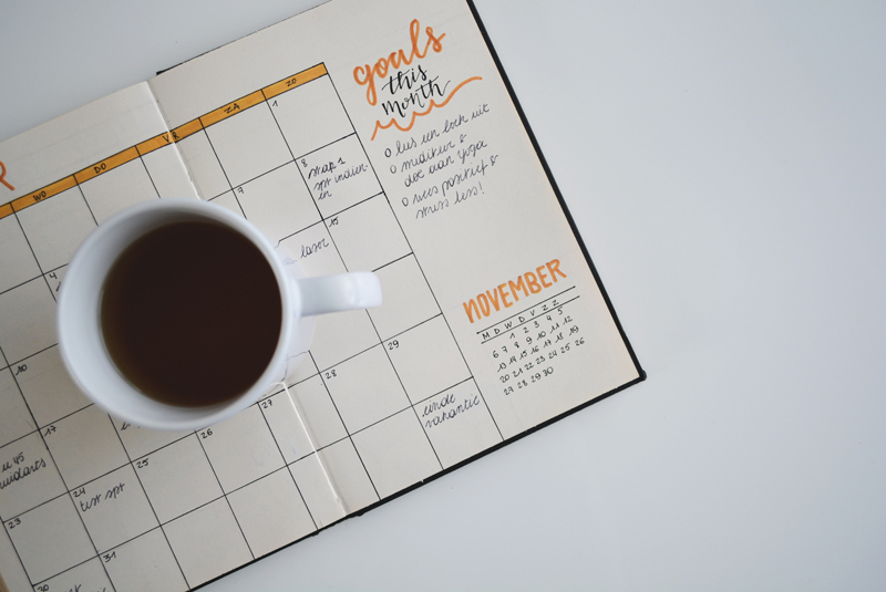 Strategic planning offsites are happening all around the world. Photo of a coffee cup on a calendar
