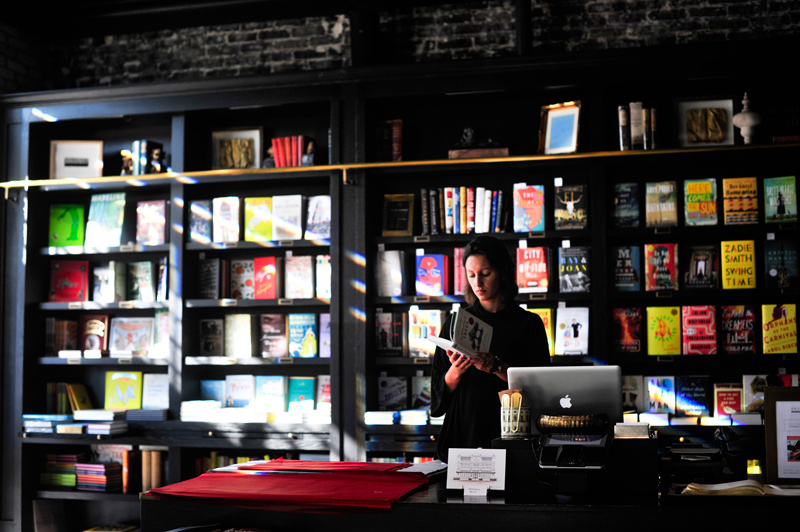 Appreciating a cashier high in examine. Photo of a bookstore cashier