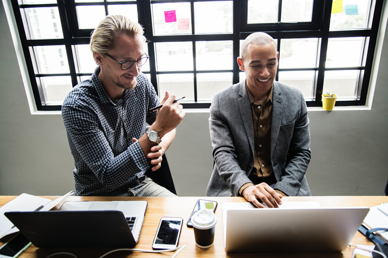 Photo of two people working together at a desk