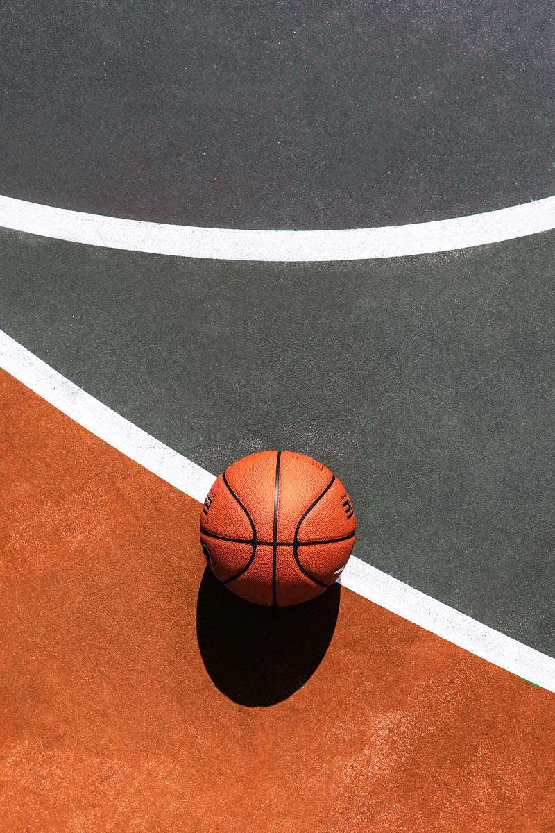 Photo of a basketball on a court outside