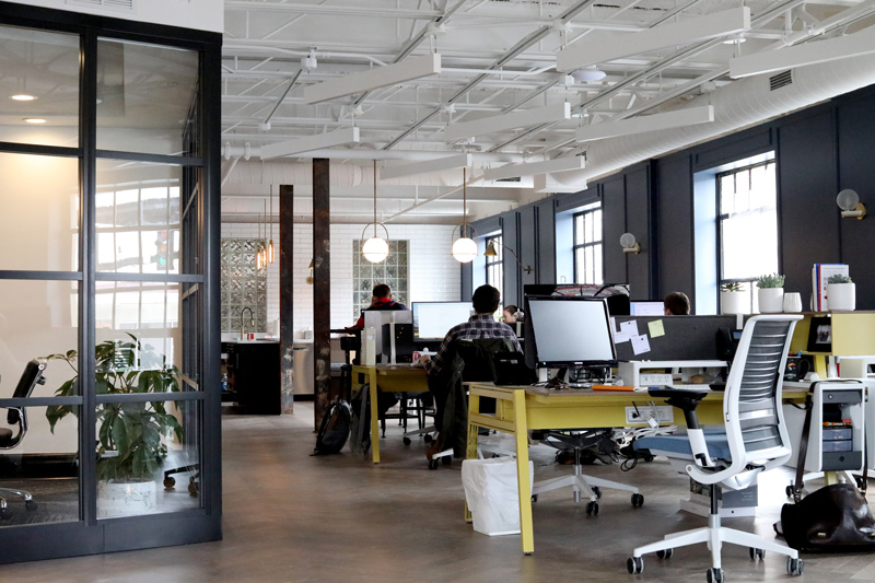 The first 90 days at a new job are like tennis. Photo of workers in an open office environment